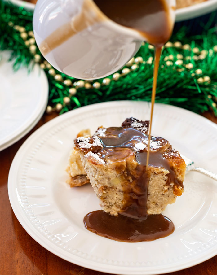 Pouring toffee sauce over bread pudding made from banana bread